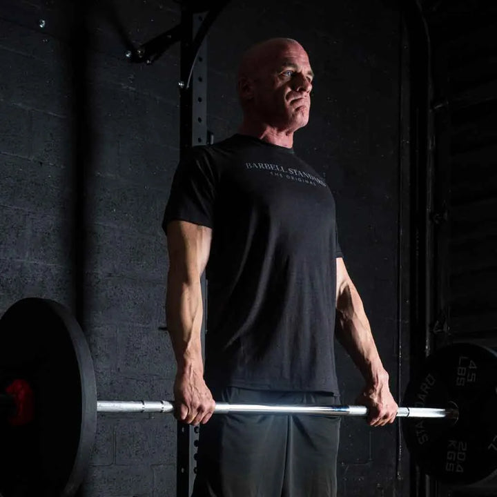 Barbell Standard 1500 Olympic Barbell with chrome finish and adjustable weight plates for weightlifting and strength training.