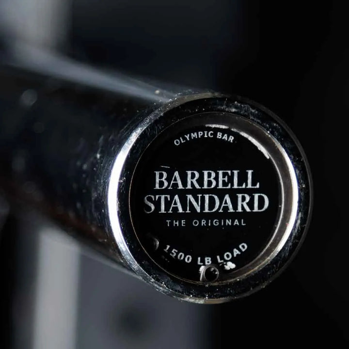Barbell Standard 1500 Olympic Barbell with knurled grip and rotating sleeves, ideal for weightlifting and strength training.
