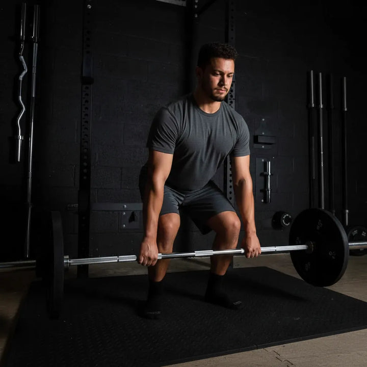 Barbell Standard 2000 Power Barbell shows a sturdy metal barbell with textured grip areas for strength training and weightlifting exercises.