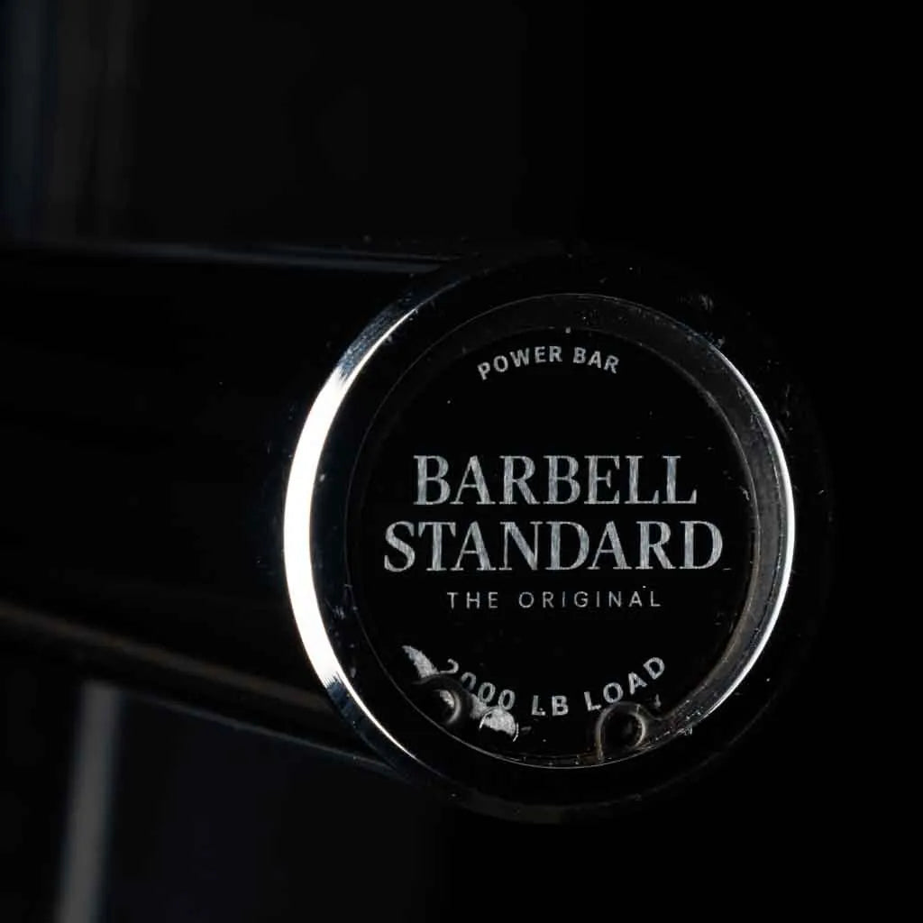 Barbell Standard 2000 Power Barbell with sturdy metal shaft and knurled grip for weightlifting and strength training.