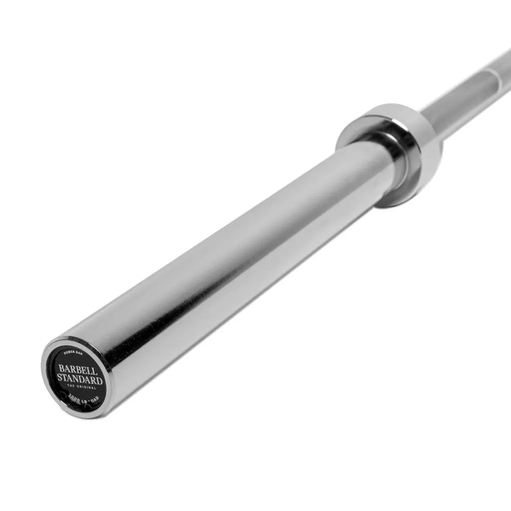 Barbell Standard 2000 Power Barbell weight set with multiple metal weight plates and a sturdy barbell for weightlifting.