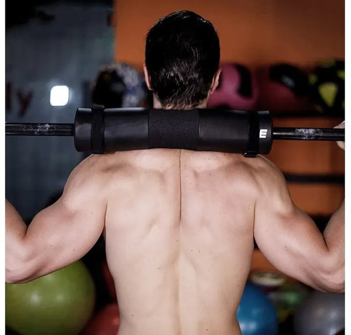 The Peak Pivot Ultimate Barbell Squat Pad wrapped around a barbell for comfort during weightlifting exercises.