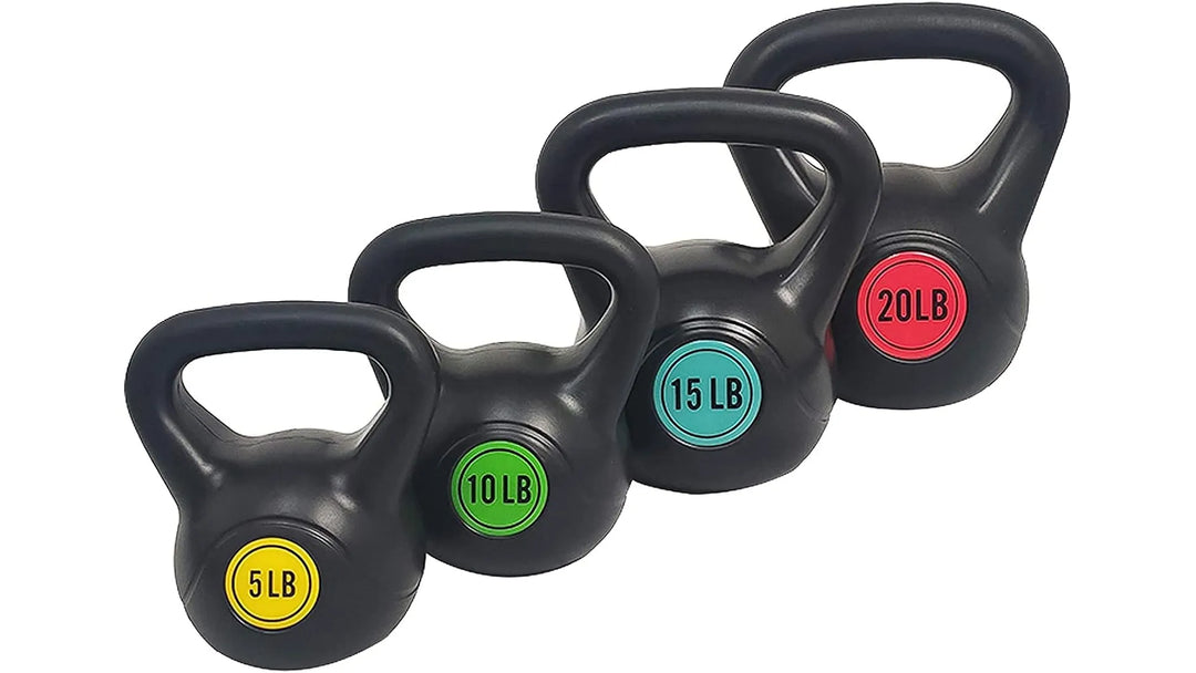 Set of black kettlebell weights from The Peak Pivot, arranged on a gym floor for strength training exercises.
