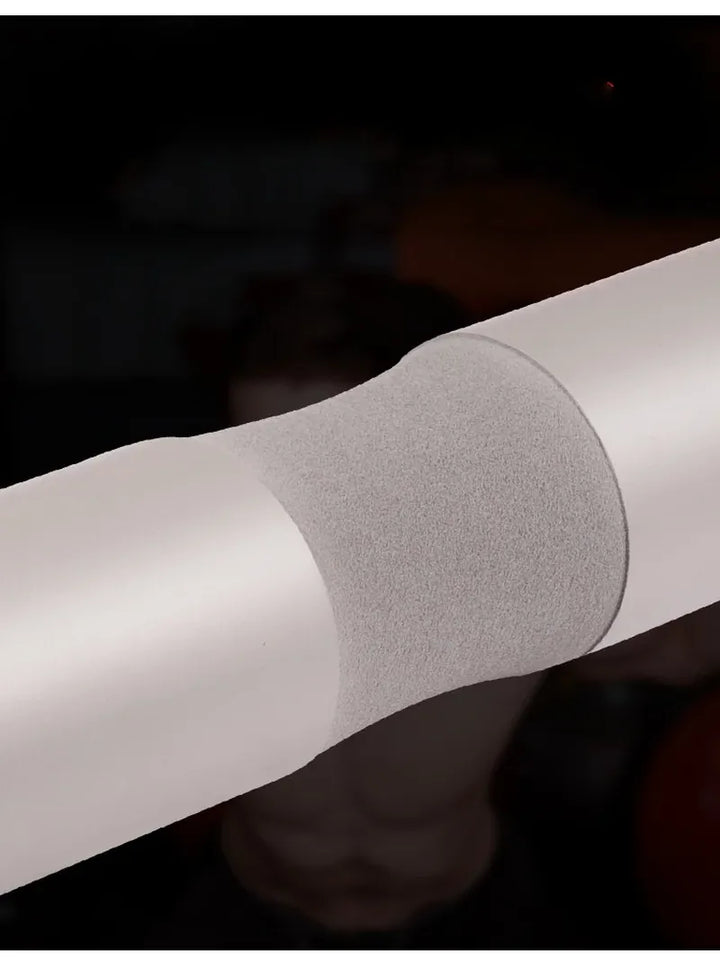 The Peak Pivot Ultimate Barbell Squat Pad wrapped around a barbell for comfortable weightlifting support.
