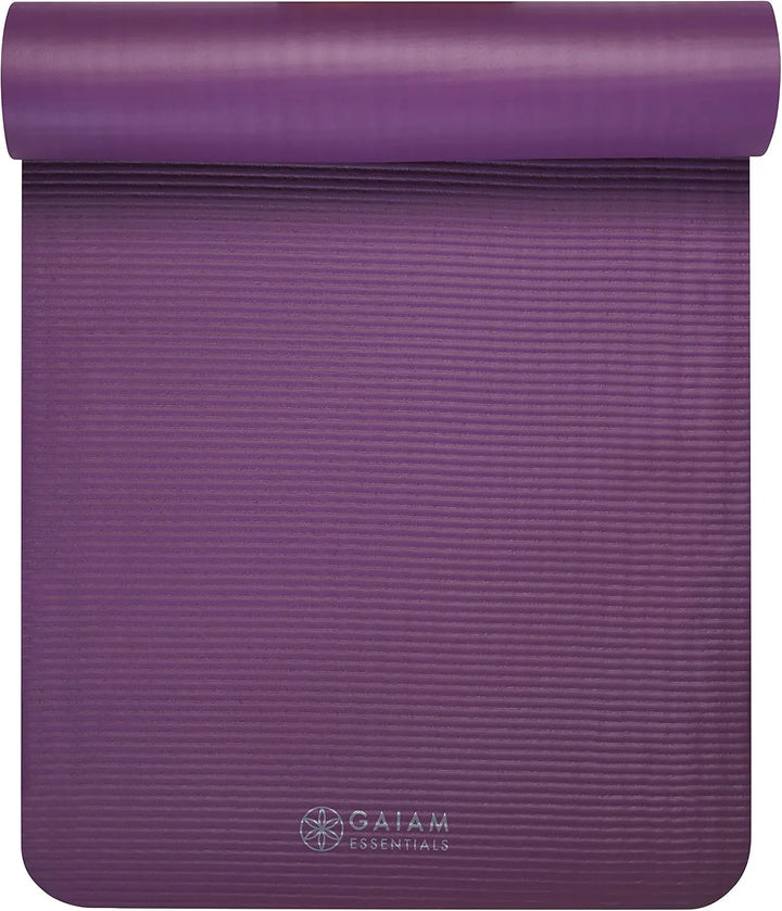 Gaiam Essentials yoga mat by The Peak Pivot laid out on a wooden floor, showing textured surface for grip and comfort.