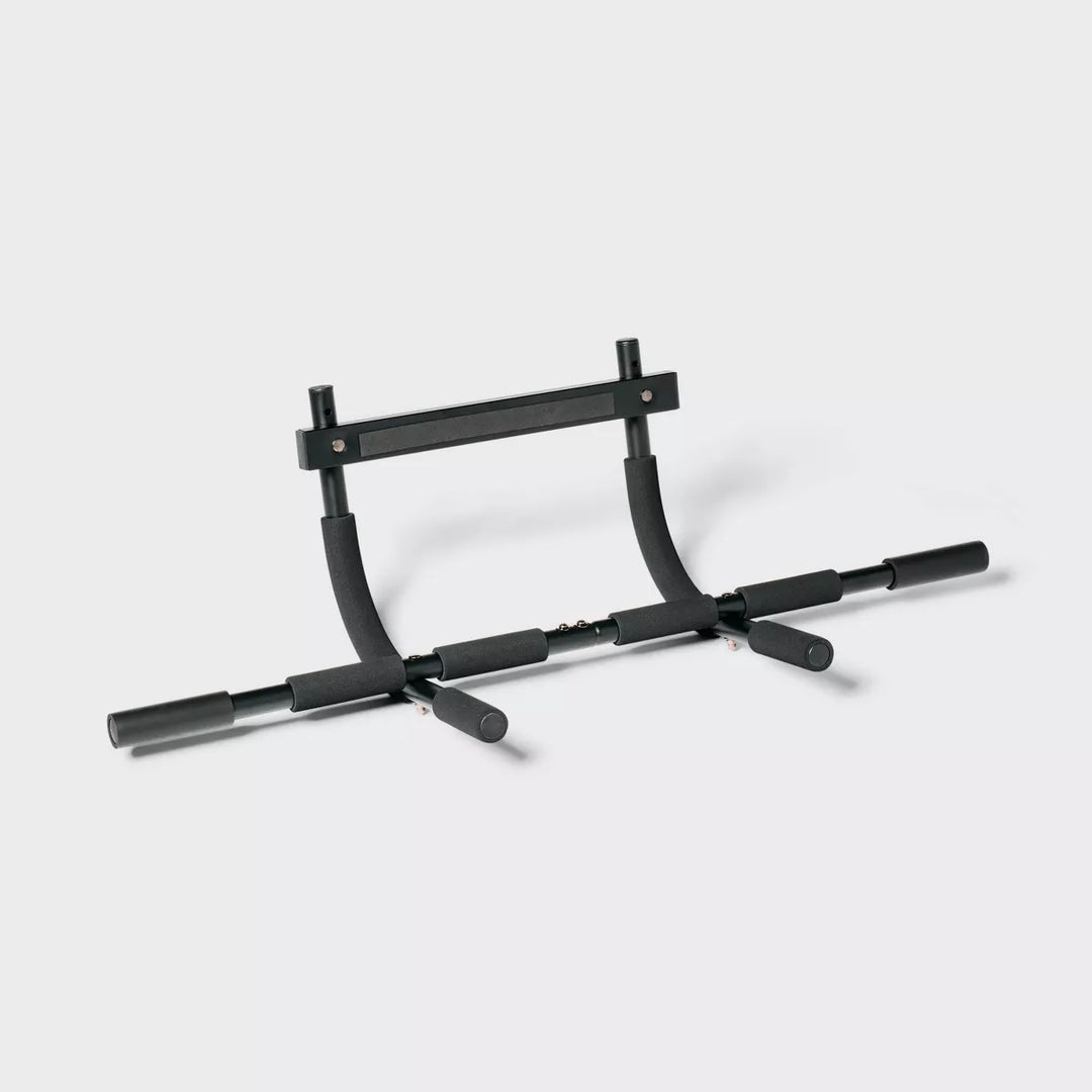 Door frame pull-up bar by The Peak Pivot for strength training, mounted across a door frame for upper body exercise.
