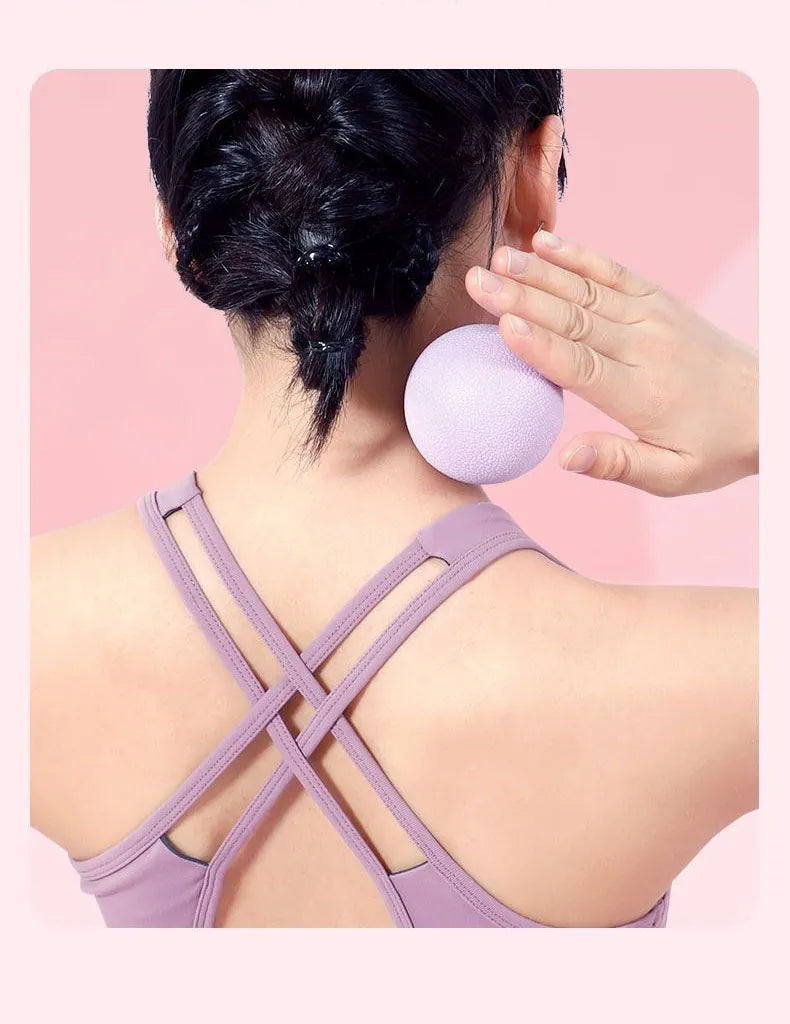 massage ball for deep tissue relief, showing a close-up of a textured black therapy ball in use
