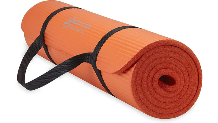 Orange Gaiam Essentials yoga mat by The Peak Pivot, showing textured surface and durable non-slip design for yoga practice.