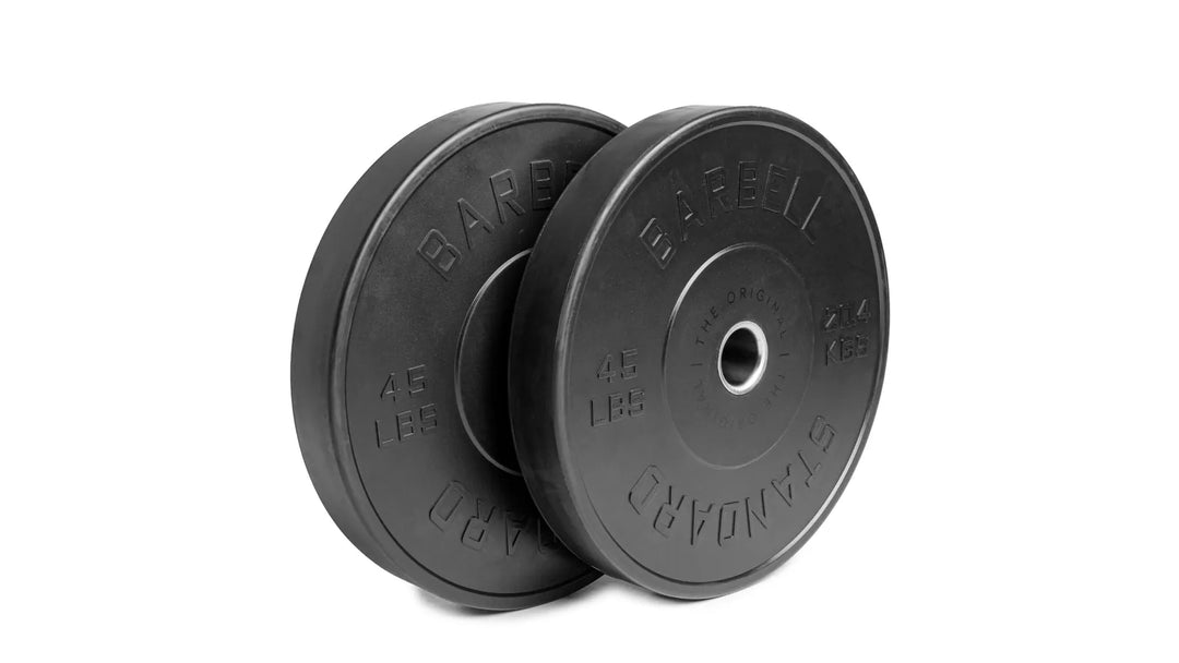 Pair of Barbell Standard Olympic bumper plates in black with white weight markings, designed for weightlifting and strength training.
