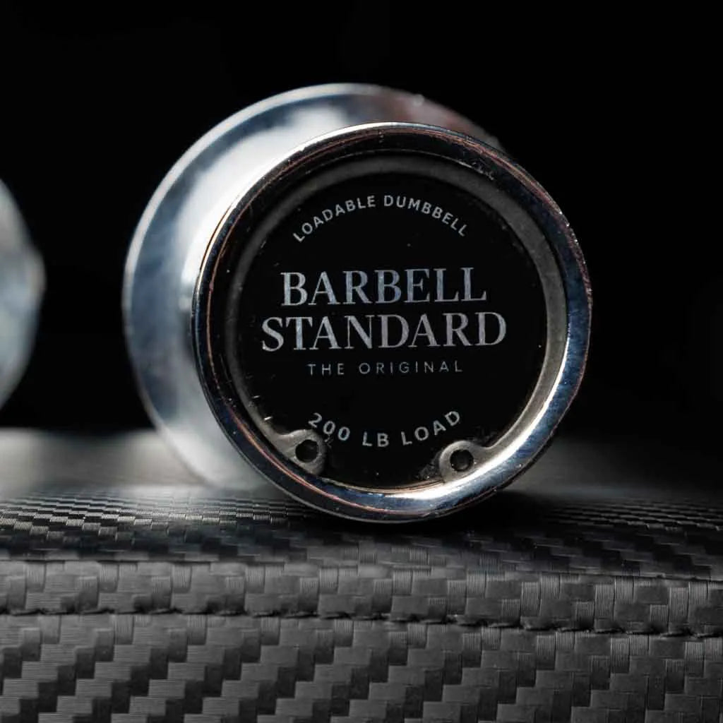 Pair of Barbell Standard loadable dumbbell bars with adjustable weight plates for strength training and fitness workouts.